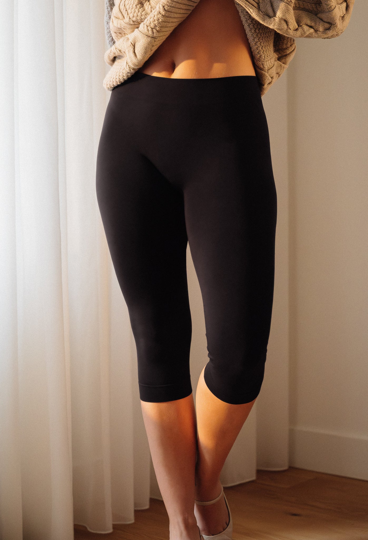 Gros plan jambes de profil portant le legging capri Chillout noir longueur 3/4 – Gamme SkinBloom – Soje Lingerie